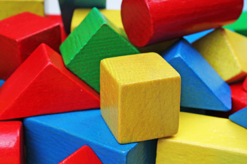 Wooden toy blocks background. Red, Blue, Yellow Green Wooden toy blocks on white background. Wood block texture pattern. Education.