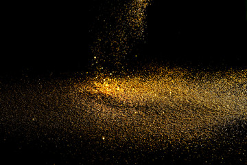 Sprinkle glitter gold dust in the dark textured abstract background elegant for Merry christmas and Happy new year