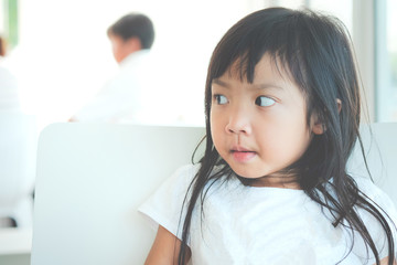 Asian child girl wearing white shirt looking at something with copy space