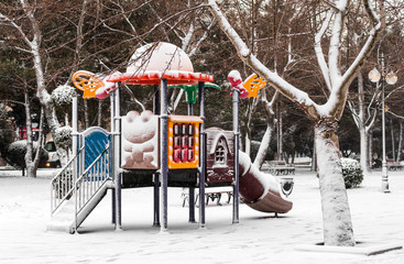 Empty playground in snowly park