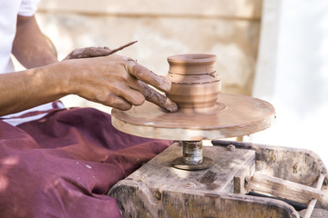 hands making a piece of pottery