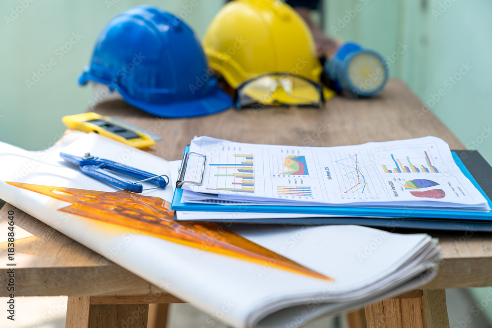 Poster architect engineer work table with safty helmet and drawing work tools on construction site