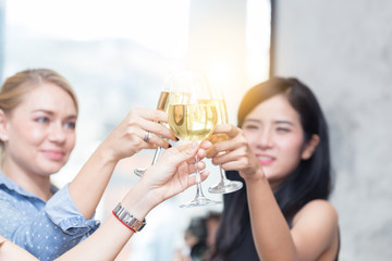 Woman friends cheering white wine after job success