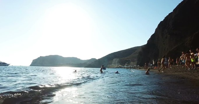 SANTORINI, GREECE &ndash; AUGUST 2016 : Video shot on Red Beach on a sunny day with people, boats and amazing landscape in view