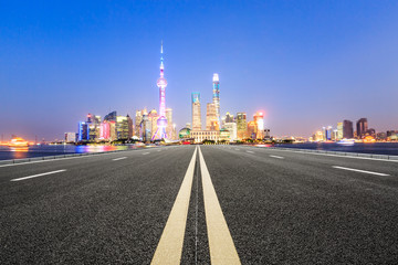Fototapeta na wymiar Asphalt road and modern city famous architectural scenery in Shanghai at night,China