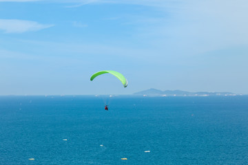 Paragliding flying through the sea and beautiful sky, Koh Lan Pattaya Thailand