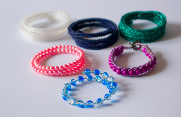 Five bracelets lie on a light background.