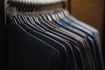 Rows of men's suit jackets in suitshop