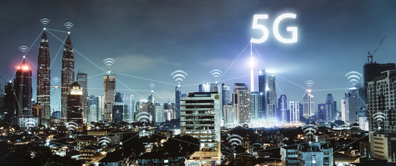 5G network wireless systems and internet of things with modern city skyline. Smart city and...
