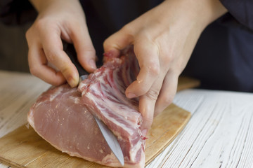 hands cook cut bones with meat