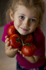 Fototapeta na wymiar girl with tomatoes in hand