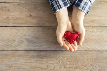 Red heart in hands