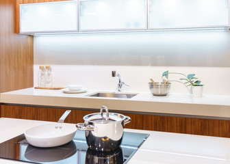 Modern, bright, clean kitchen interior with stainless steel appliances in a luxury apartment.