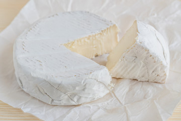 closeup of camembert on white paper