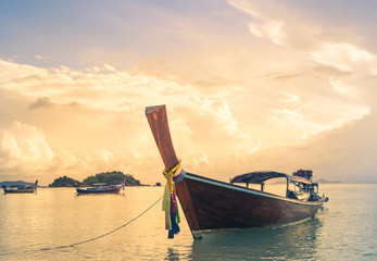 long tailed boat, fishing boat, motor boat on the sunset scene