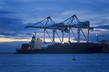 Naklejka premium Containers loading by crane at Sunset, Trade Port , Shipping
