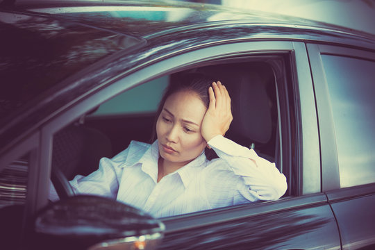 Stressed of asian woman driver sitting inside her car