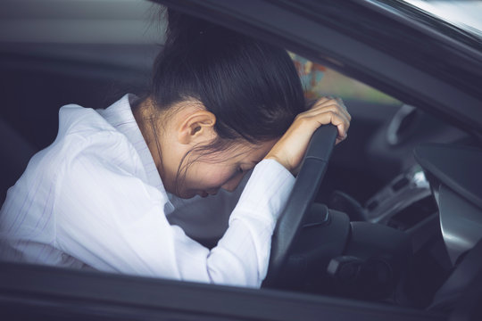 Stressed of asian woman driver sitting inside her car