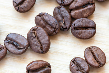 closeup coffee beans on white wooden background.