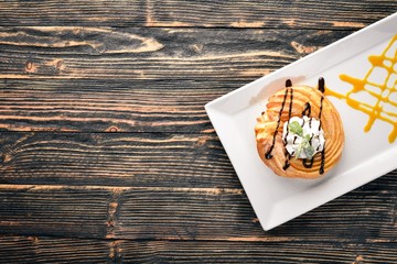 Cream Cake with Cream. On a wooden background. Free space for your text. Top view.