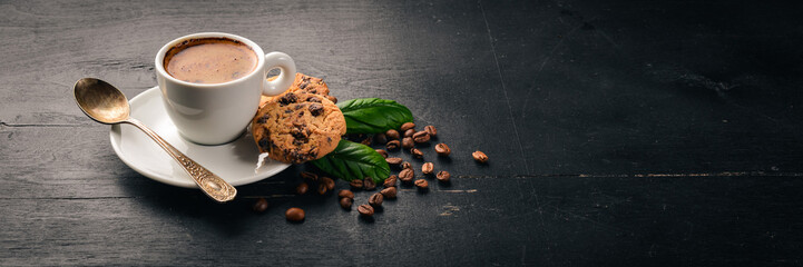 Coffee and oatmeal chocolate cookies on a wooden background. Coffee beans. Top view. Free space for text.