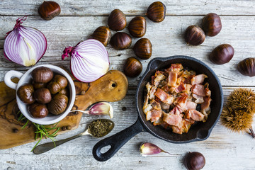 Fried pancetta and chestnuts, ingredients for chestnut soup. Italian food.