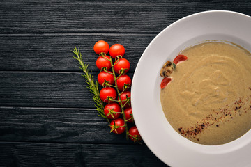 Mushroom puree soup. On a wooden background. Free space for your text. Top view.