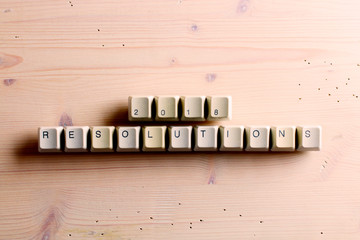 Resolutions 2018. on computer keyboard keys buttons on a wooden background