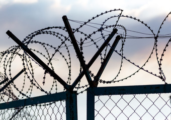 Fence with barbed wire as a background