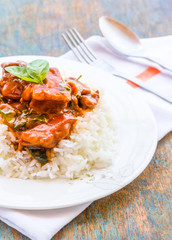 Chinese Chicken Served with Rice and Basil in a White Plate