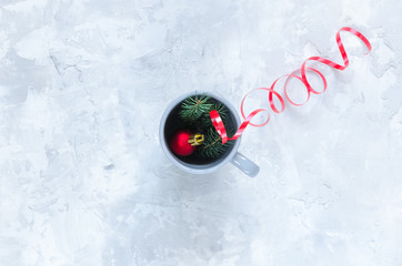 Fir toy, fir branches and cup on concrete background