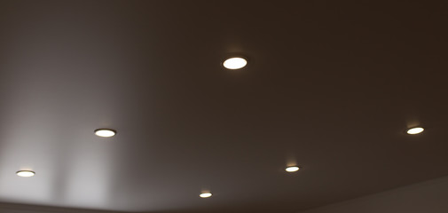 lamps on a stretch ceiling in a room