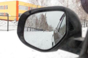 Reflection in the mirror of auto winter