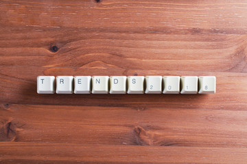 Trends 2018 concept on computer keyboard keys on a wooden background