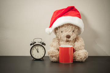 Teddy bear with red santa hat.