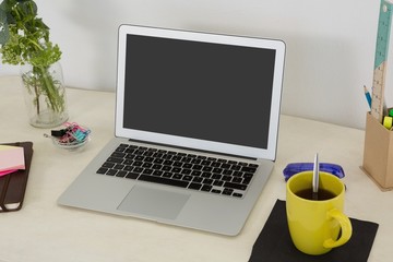 Fototapeta premium Laptop and various office accessories on table