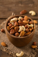 mixed nuts on wooden surface
