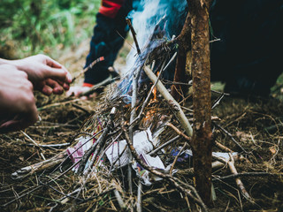 Obraz premium close up shot of man making a fire in the forest