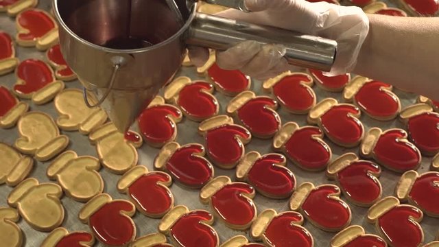 Jam pour into the cookies. Jam and cookies. Red jam. Red cream.