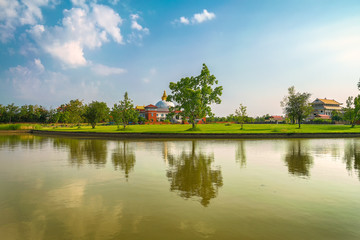 Fototapeta na wymiar magical landscape with small lake and beautiful reflections in land of temples in nepal. lumbini