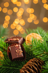 Luxury handmade bonbons on christmas background with bokeh