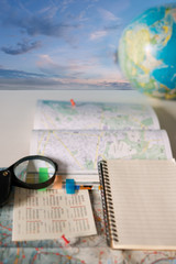 Travel concept with map and globe with idyllic sky in the background