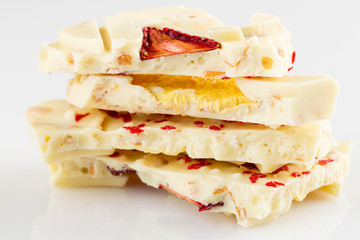 Stack of white chocolate bar pieces with dried fruit