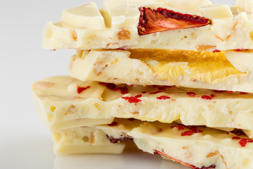 Stack of white chocolate bar pieces with dried fruit