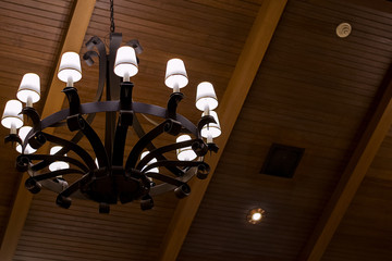 Chandelier on wooden ceiling 