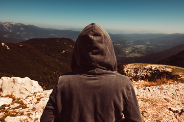 Mountain hiker at high viewpoint looking at the valley