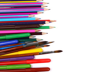 Colorful felt pen markers, pencils, paint brushes and art utensils isolated on white background, top view