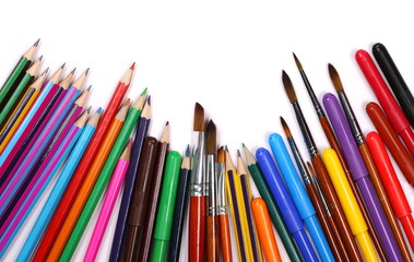 Colorful felt pen markers, pencils, paint brushes and art utensils isolated on white background,...