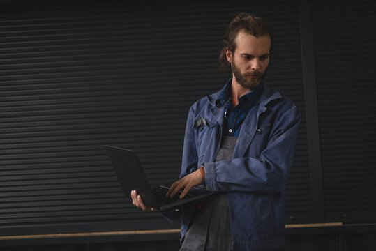 Mechanic using laptop