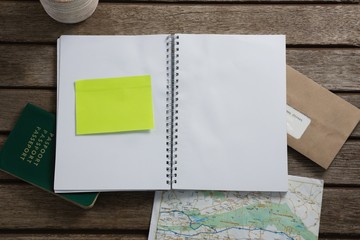 Passport, map, organizer and envelope on wooden table